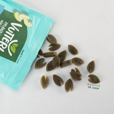 Aus einer offenen Tüte veganer Leckerli für Hunde wie Fisch von Vutter! sind ein paar Snacks herausgefallen